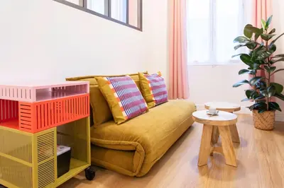 a living room with a yellow couch and a table at L59 Appartment La Loge Vieux Nice, central AC & WIFI in Nice