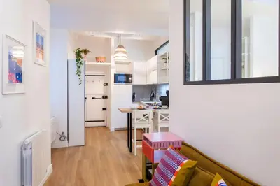 a living room with a couch and a kitchen at L59 Appartment La Loge Vieux Nice, central AC & WIFI in Nice