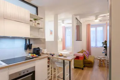 a kitchen with a counter and a table in a room at L59 Appartment La Loge Vieux Nice, central AC & WIFI in Nice