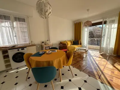 a living room with a table and chairs at Sunny Gambetta with 3 air conditionings in Nice