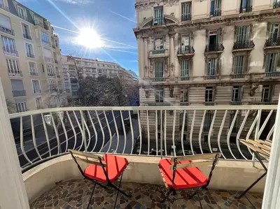two chairs sitting on a balcony in front of a building at Sunny Gambetta with 3 air conditionings in Nice