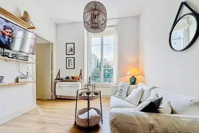 a living room with a couch and a tv at Charming 2-Bedroom Retreat Near City Center with Excellent Transport Links in Nice