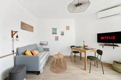 a living room with a couch and a table at Vista Nissa - À Quelques Pas du Port in Nice