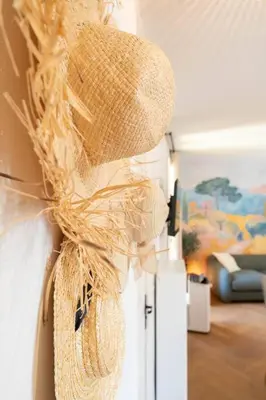 a straw hat is hanging on a wall at Superbe appartement deux chambres, centre proche port in Nice