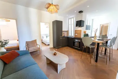 a living room with a blue couch and a table at Superbe appartement deux chambres, centre proche port in Nice