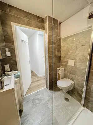 a bathroom with a toilet and a glass shower at Studio proche mer - Climatisé in Cagnes-sur-Mer
