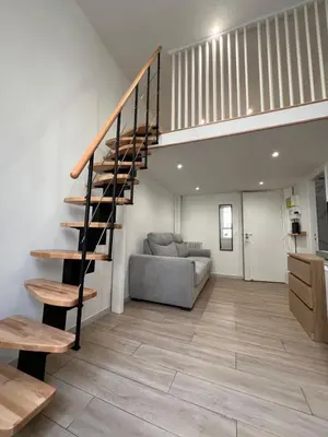 a living room with a staircase and a couch at Studio Roma - Jean Médecin - LA RIVIERA LCD in Nice