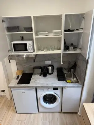 a small kitchen with a washing machine and a microwave at Studio Roma - Jean Médecin - LA RIVIERA LCD in Nice