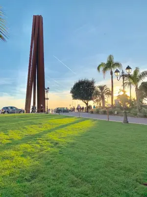 a grassy field with palm trees and a monument at Studio Roma - Jean Médecin - LA RIVIERA LCD in Nice
