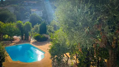 a living room with two chairs and a table and a window at Maison LeFleur - Villa avec piscine sur les hauteurs de Nice in Nice