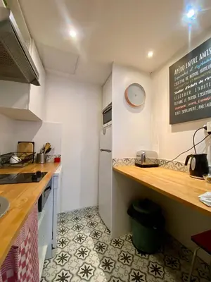 a small kitchen with a counter top and a sink at Joli appartement niçois en bord de mer in Nice
