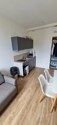 a living room with a couch and a kitchen at Ete Nice in Nice