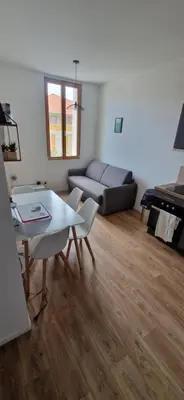 a living room with a couch and a table at Ete Nice in Nice