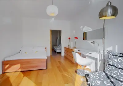 a bedroom with a bed and a desk and a chair at MyrAzur Carre d'Or in Nice