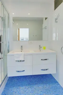 a white bathroom with a sink and a mirror at MyrAzur Carre d'Or in Nice