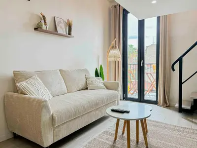 a living room with a couch and a table at Potiers - parking, Wifi, 2pers in Nice