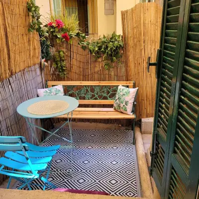 a patio with a table and a bench and a table and chairs at Studio centre ville in Nice