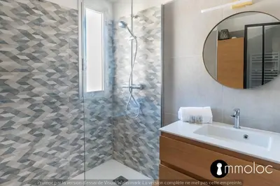 a bathroom with a shower with a sink and a mirror at Air-conditioned apartment facing the port of Saint Laurent with 2 bedrooms in Saint-Laurent-du-Var