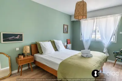 a bedroom with a bed and a window at Air-conditioned apartment facing the port of Saint Laurent with 2 bedrooms in Saint-Laurent-du-Var