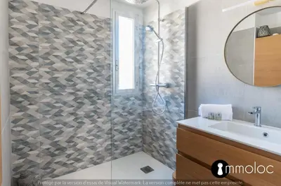 a bathroom with a shower with a sink and a mirror at Air-conditioned apartment facing the port of Saint Laurent with 2 bedrooms in Saint-Laurent-du-Var