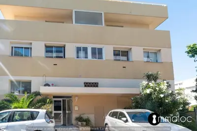 two cars parked in front of a building at Air-conditioned apartment facing the port of Saint Laurent with 2 bedrooms in Saint-Laurent-du-Var