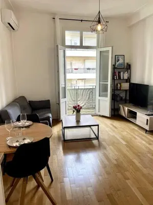 a living room with a table and a couch at Appartement Niçois in Nice