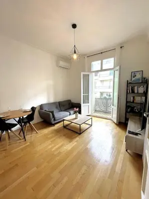 a living room with a couch and a table at Appartement Niçois in Nice