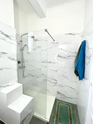 a bathroom with a shower with a glass door at Appartement Niçois in Nice