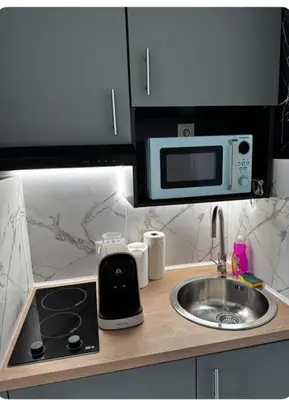 a kitchen counter with a sink and a microwave at Studio en bord de mer, Plage 20m, Clim in Cagnes-sur-Mer