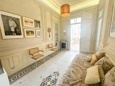 a living room with a couch and a chair at Appartement exceptionnel belle époque avec grande terrasse plein sud in Nice