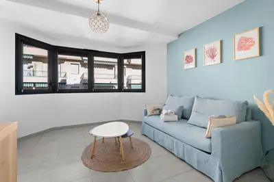 a living room with a blue couch and a table at Studio Amanda - Welkeys in Nice