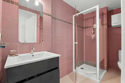 a pink bathroom with a sink and a shower at Studio Amanda - Welkeys in Nice