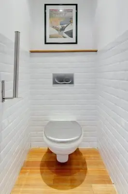 a white toilet in a bathroom with a wooden floor at Rue Fodere location Port area in Nice