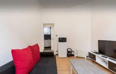 a living room with a bed and a flat screen tv at Studio confortable à Nice - 19 m² avec vue sur la ville in Nice