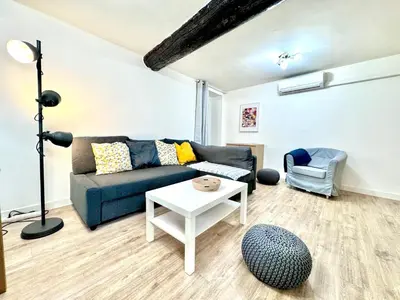 a living room with a couch and a table at ApartHotel Riviera - ANGLE DROITE - Old town Promenade des Anglais in Nice