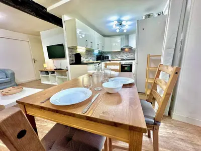 a wooden table with plates on it in a kitchen at ApartHotel Riviera - ANGLE DROITE - Old town Promenade des Anglais in Nice