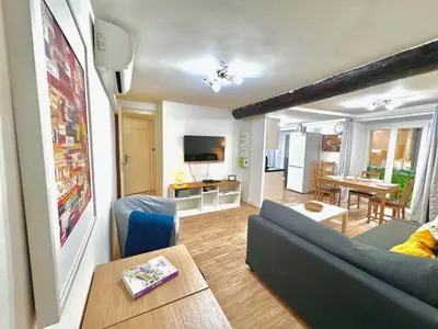 a living room with a couch and a table at ApartHotel Riviera - ANGLE DROITE - Old town Promenade des Anglais in Nice