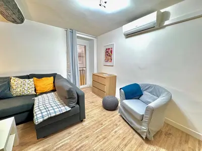 a living room with a couch and a chair at ApartHotel Riviera - ANGLE DROITE - Old town Promenade des Anglais in Nice