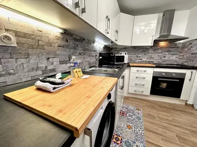a kitchen with a wooden counter top in a room at ApartHotel Riviera - ANGLE DROITE - Old town Promenade des Anglais in Nice