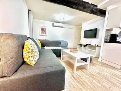 a living room with a couch and a table at ApartHotel Riviera - ANGLE DROITE - Old town Promenade des Anglais in Nice