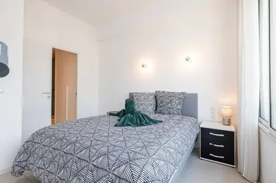 a bedroom with a bed with a green dinosaur on it at Royal Riviera in Nice