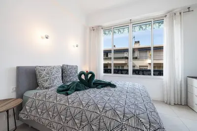 a bedroom with a bed with a ribbon on it at Royal Riviera in Nice