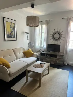 a living room with a couch and a table at Vieux Nice in Nice