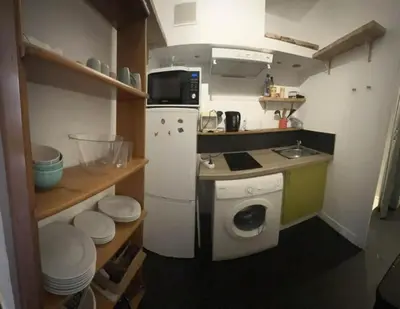 a small kitchen with a refrigerator and a washing machine at Vieux Nice in Nice