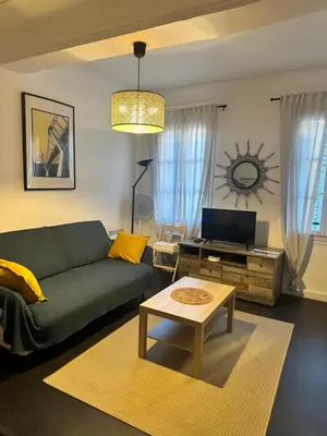 a living room with a green couch and a table at Vieux Nice in Nice