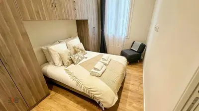 a small bedroom with a bed with white sheets and pillows at Le Petit Saint Barth- Easy Home Booking in Nice