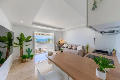 a living room with a couch and a table at 06K1 - Front of the sea-renovated-terraceparking in Saint-Laurent-du-Var