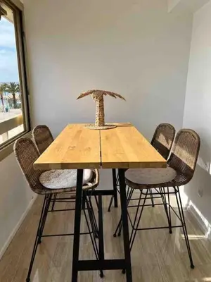 a wooden table with chairs and a bonsai tree on top at 06K1 - Front of the sea-renovated-terraceparking in Saint-Laurent-du-Var