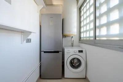 a laundry room with a washing machine and a window at Superbe 3p vue mer avec parking in Nice