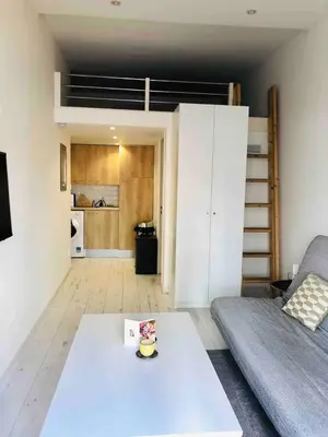 a living room with a couch and a table at Studio Nice Centre 4P Jean médécin avenue in Nice